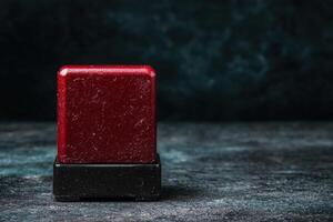 Vibrant red soap bar on dark background photo
