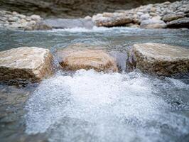 flowing mountain stream with rocks photo