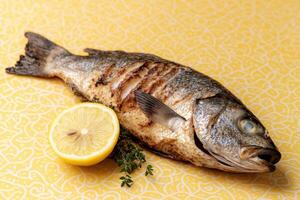Grilled fish with lemon and herbs photo