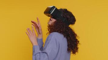 Young woman using virtual reality headset helmet to play simulation game app, watching content video