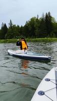 Embark on an exciting paddleboarding adventure in the serene and peaceful waters around you video
