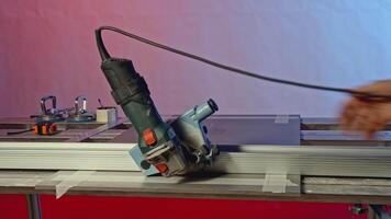 Using circular saw to cut board at the workshop. Creative. Industrial background with professional equipment. video