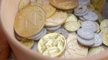 A Colorful and Diverse Assortment of Coins Displayed Beautifully Within a Container. Action video