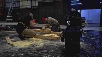Carpenters using professional equipment at the workshop. Media. Working with wooden beams. video