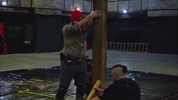 Workers installing wooden beam for the performance. Media. Creative stage decoration details. video