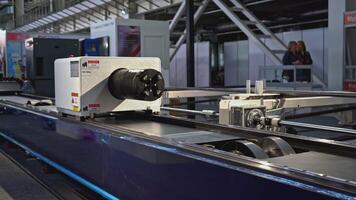 Automated laser cutting machine for metal pipes. Media. Moving machine on rails of industrial conveyor. Automated laser machine moving in industrial workshop video
