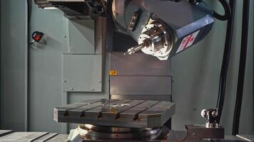 Rotating automated Machine with metal plate and drill. Media. Automated machine with drill and metal plate for operation. Machine is being prepared to work with automated hand video