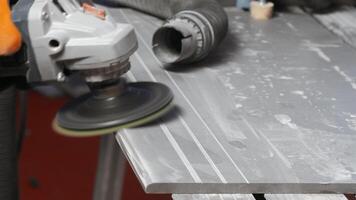 Process of grinding raw wood plank with angle grinder in workshop. Creative. Flying wood dust while polishing timber surface. video