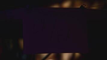 Notes with words on strings in office. Stock footage. Words on stickers in night office illuminated by lantern. Mysterious quest with puzzles on notes video