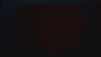 Mystical notes on ropes. Stock footage. Night notes on ropes with rebus in office. Mysterious words on notes in night office video