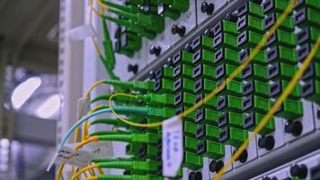 Close up of optical fiber switchboard hub in a server room. Stock footage. Concept of AI, internet, and modern technologies. video