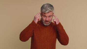 Middle-aged man pointing at camera and showing stupid gesture, blaming some crazy idiot, out of mind video