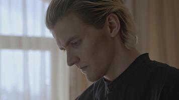 Close-up of man worried and worried. Stock. Attractive young man is emotionally stressed and anxious. Man with different emotions is experiencing stress from situation that happened video