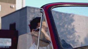 Young man turning the handle of mechanical window lifter and tearing it off. Stock. Man leaving the cabriolet car after breaking. video