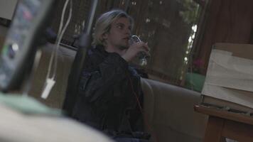 Man excitedly drinks bottle of water. Stock. Young man drinks bottle of water in one gulp. Man hesitantly drinks water from bottle video