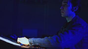 Technician works at stage console. Media. Young man is working at console of modern stage. Stage light and sound control panel video