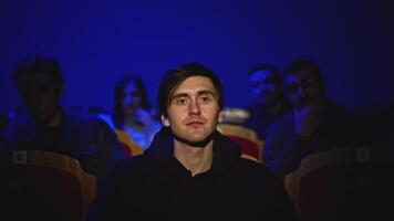 Young man is watching theatrical performance. Media. Man is watching theatrical performance in place. Spectator illuminated by spotlight at theatrical performance video