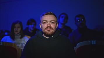 Young man is watching theatrical performance. Media. Man is watching theatrical performance in place. Spectator illuminated by spotlight at theatrical performance video