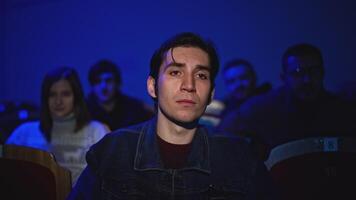 Young man is watching theatrical performance. Media. Man is watching theatrical performance in place. Spectator illuminated by spotlight at theatrical performance video