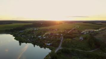 Enjoy the Serene Aerial View of a Beautiful and Tranquil Village Set at Sunset Time. Stock Clip video