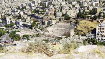 A Panoramic View of an Ancient Roman Theater Situated Within a Modern Urban Cityscape. Action video