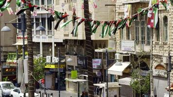 A lively and vibrant street scene with colorful flags and banners in an urban setting. Action video