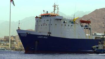 The impressive Cargo Ship named Lady Muf is currently docked in the busy port area. Action video