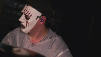 Man in mask plays rock drums. Clip. Man in scary mask is playing drums. Musical performance with playing drums in mask for video