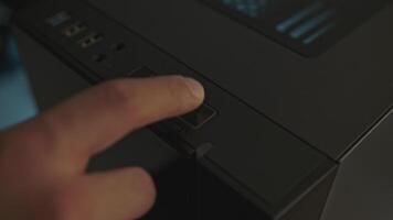 Close-up of man pressing computer start button. Clip. Man turns on modern computer. Gaming professional PC with beautiful design video