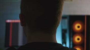 Man is working at professional computer with backlight. Clip. Man is working at computer with backlight. Programmer or gamer with stylish computer setup video
