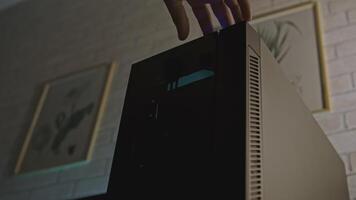 Computer with backlight. Clip. Man turns on computer with backlight inside. Beautiful stylish computer processor design with backlight for gaming and work video