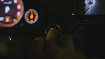 Close-up of man pressing car power button. Clip. Man starts car by pressing button. Modern car ignition technologies video