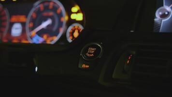 Close-up of man pressing car power button. Clip. Man starts car by pressing button. Modern car ignition technologies video