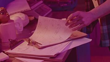 Mathematician looking at calculations. Media. Mathematical notes on notebook in laboratory. Experimental room with mathematical calculations and records video