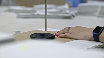 Close up of using cuttinedge tool at the clothes factory. Media. Concept of professional equipment at the atelier. video