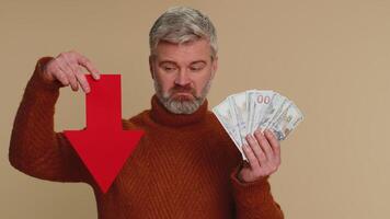 Upset man showing red arrow pointing down, concept of downgrade bankruptcy money dollar fail, fall video