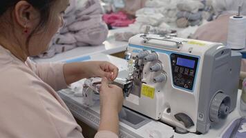 Worker activity in a textile factory. Media. Big sewing machine factory. video