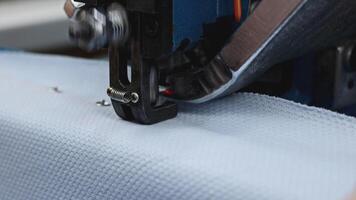 Automatic punching press machine at sewing factory. Media. Installing buttons on cloth with snap button machine. video