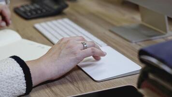 Close up of elegant female hand with a ring on her finger typing on white keyboard. Media. Director at work by the computer. video