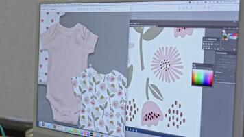 Fashion designer in office making design of baby jumpsuit. Media. Using computer to create a pattern for children clothes. video