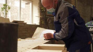 Dedicated Craftsman Working Diligently in a Workshop While Wearing a Protective Mask. Stock Clip video