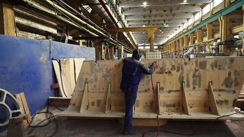 Exceptional Craftsmanship in Boat Building A Skilled Worker Diligently at Work and Crafting. Stock Clip video