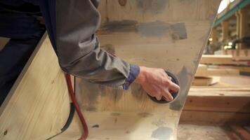 A skilled craftsman is expertly sanding a wooden surface in a well equipped workshop setting. Stock Clip video