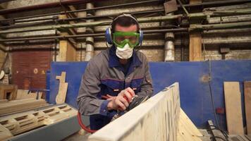 A skilled craftsman is diligently working on a wood project in his well equipped workshop. Stock Clip video