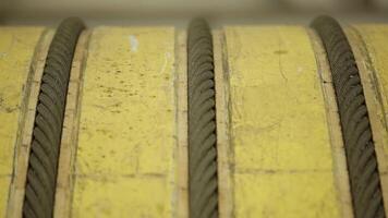 Close-Up of Textured Yellow Surfaces and Rope in an Industrial Setting with Various Elements. Stock Clip video