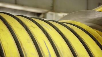 Coiled Industrial Yellow Rubber Hose Stored in a Warehouse Environment for Easy Access and Use. Stock Clip video