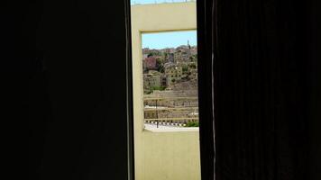 A Stunningly Beautiful View Seen Through an Open Window, Showcasing a Scenic Landscape Beyond. Action video
