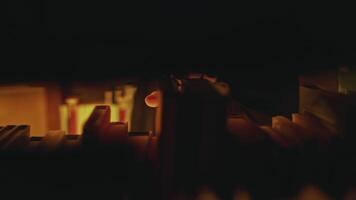 Man with a flashlight at night looking for documents in library. Stock footage. Man using flashlight to find a book on bookshelves. video