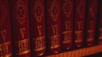 Close up of the books on the shelves of the library. Stock footage. Dark light in a room with books. video