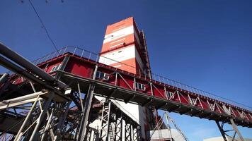 The Industrial Structure Stands Tall Against the Clear Blue Sky, Creating a Stunning Contrast. Stock Clip video